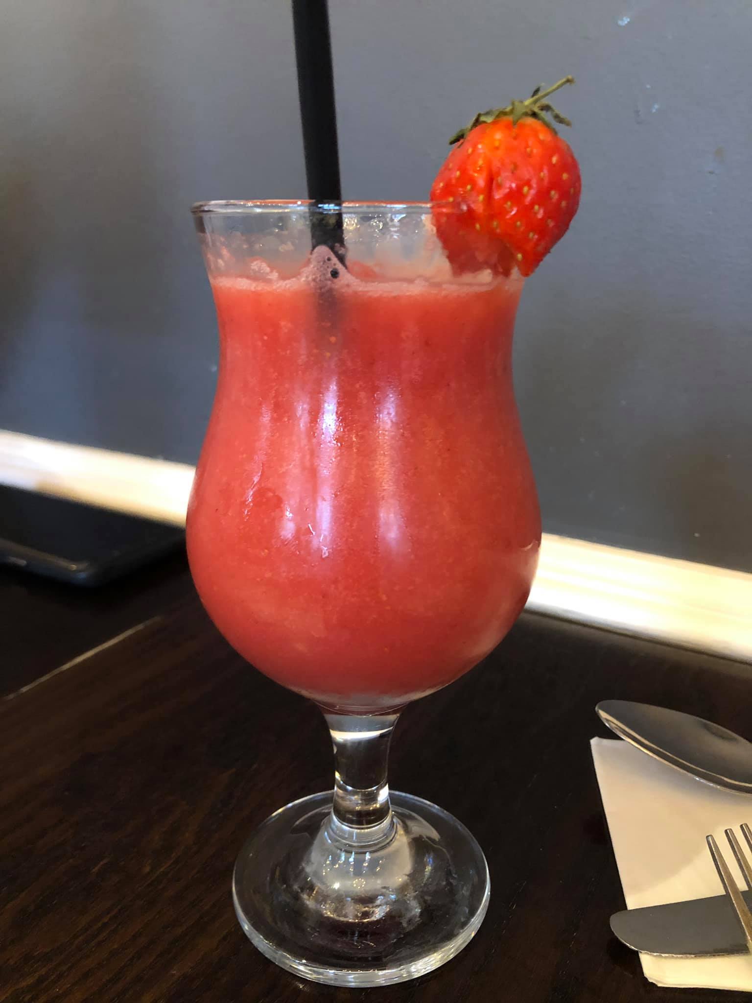 Strawbery Juice in a glass decorated with strawberry on the glass