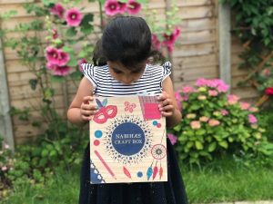 Child holding personalised craft box from Happiness is a Gift